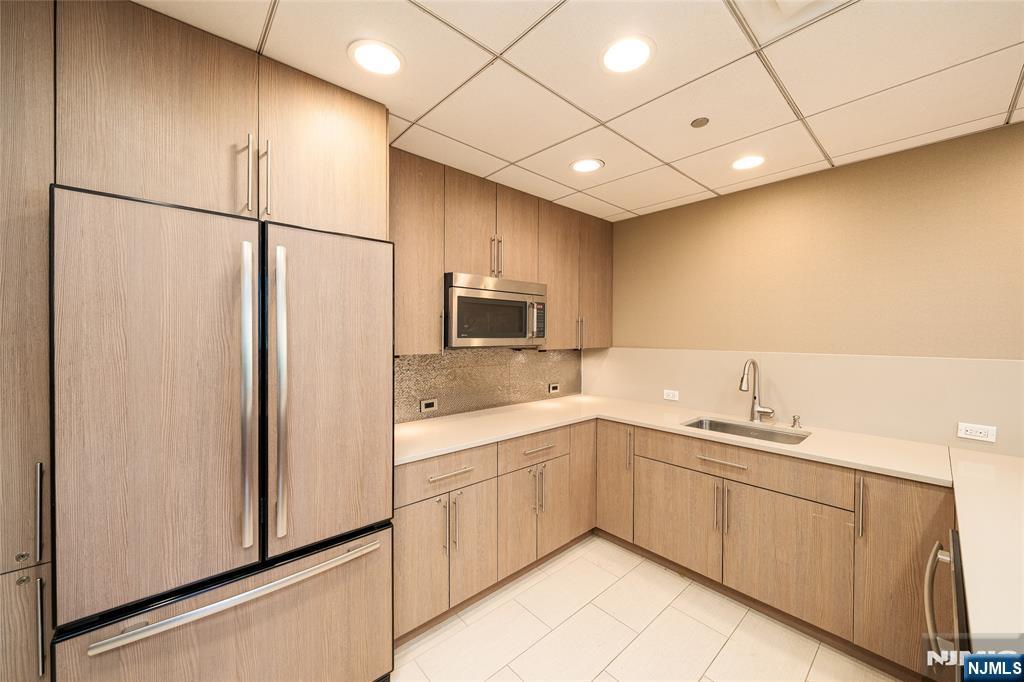 250 Gorge Road, Unit 14J Cliffside Park, NJ 07010 - Photo 34 of 45 a kitchen with a sink stainless steel appliances and cabinets