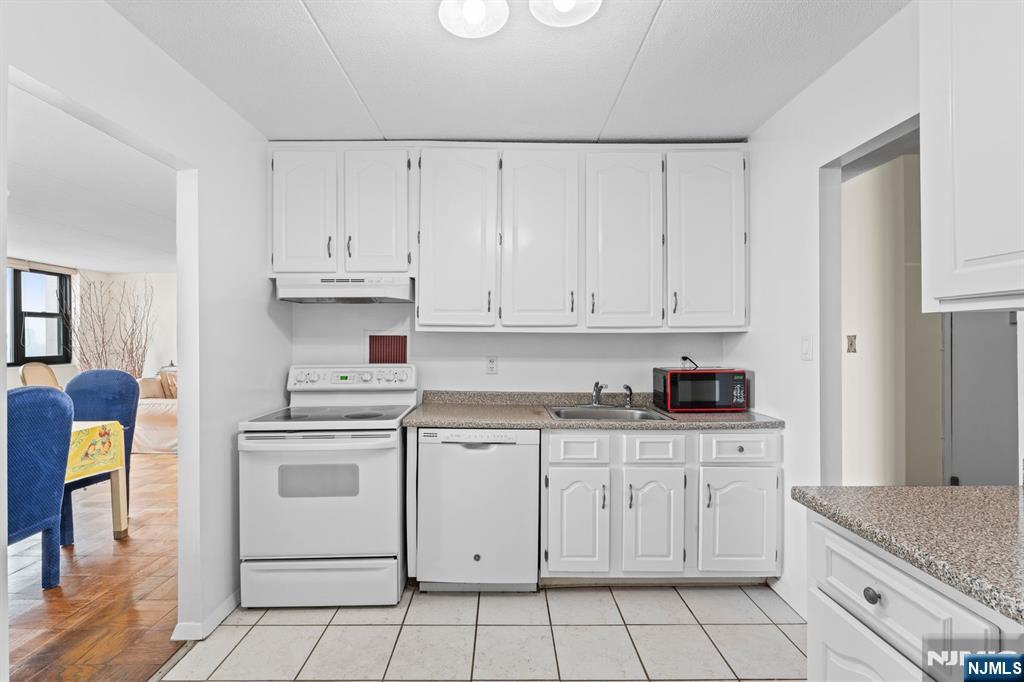250 Gorge Road, Unit 14J Cliffside Park, NJ 07010 - Photo 7 of 45 a kitchen with white cabinets appliances and a sink