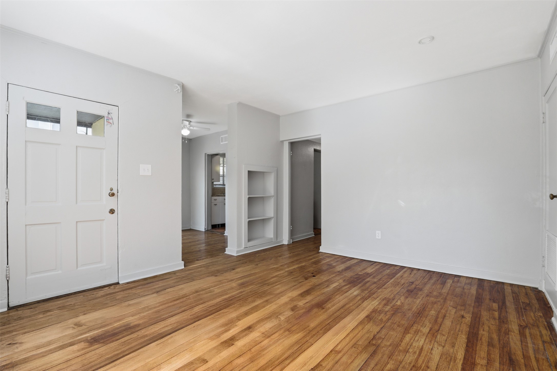 3901 Wrightwood Road, Unit A Austin, TX 78722 - Photo 4 of 11 Hardwood flooring extending throughout and built-in shelving.