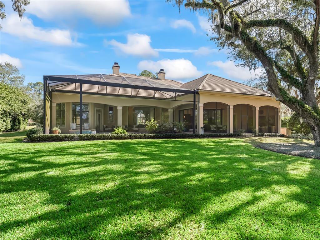 3848 Northwest 85th Terrace Ocala, FL 34482 - Photo 27 of 62 a view of a white house with a yard table and chairs