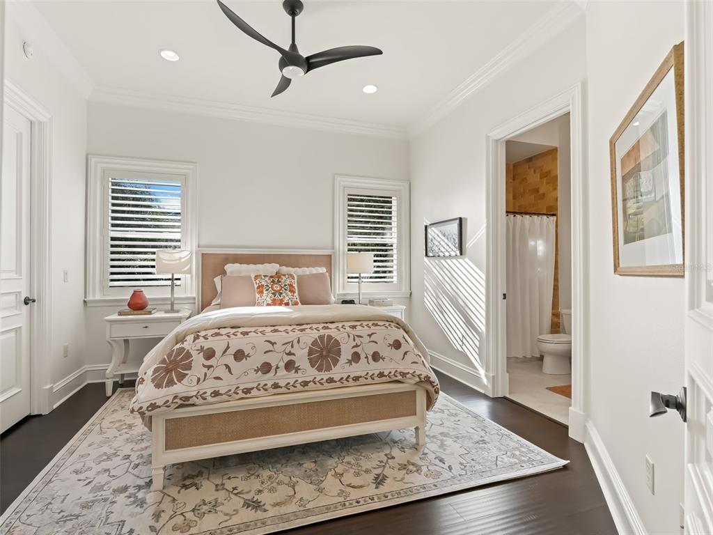 3848 Northwest 85th Terrace Ocala, FL 34482 - Photo 41 of 62 a bedroom with a large bed and wooden floor