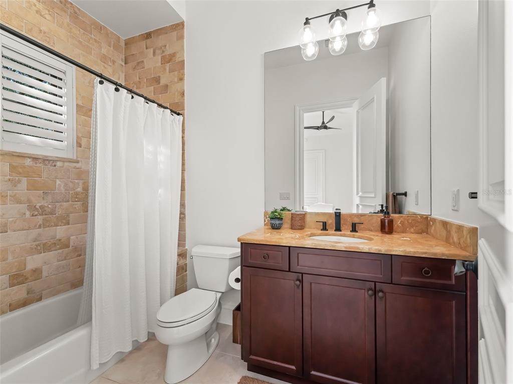 3848 Northwest 85th Terrace Ocala, FL 34482 - Photo 42 of 62 a bathroom with a granite countertop sink toilet a large mirror and shower