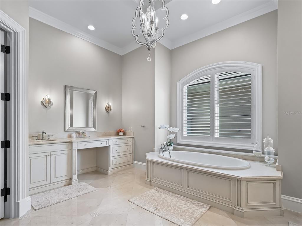 3848 Northwest 85th Terrace Ocala, FL 34482 - Photo 47 of 62 a spacious bathroom with a sink a large mirror and a bathtub