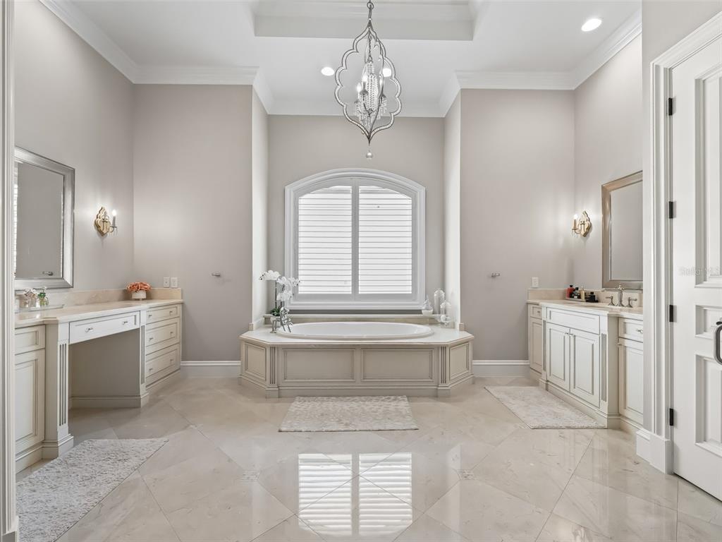 3848 Northwest 85th Terrace Ocala, FL 34482 - Photo 51 of 62 a spacious bathroom with a granite countertop sink a toilet a mirror and vanity