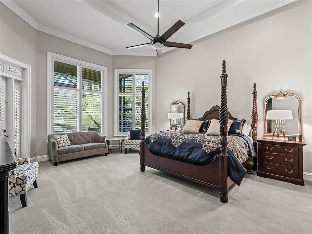 3848 Northwest 85th Terrace Ocala, FL 34482 - Photo 53 of 62 a spacious bedroom with a bed a couch and a large window