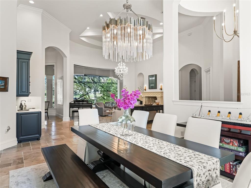 3848 Northwest 85th Terrace Ocala, FL 34482 - Photo 9 of 62 a large living room with furniture and a chandelier