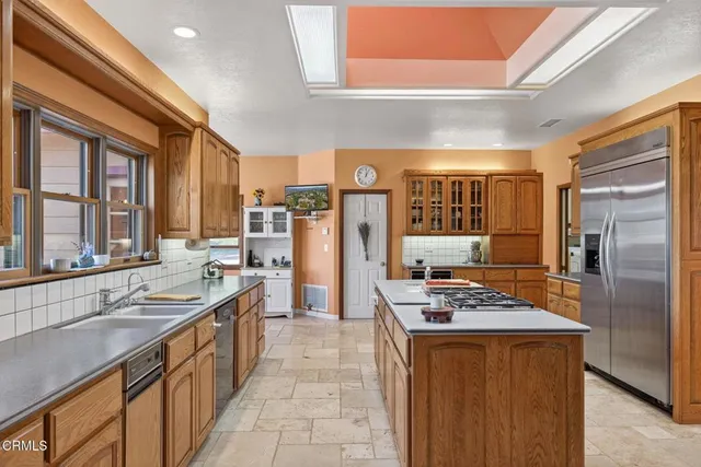 a kitchen with stainless steel appliances granite countertop a stove top oven