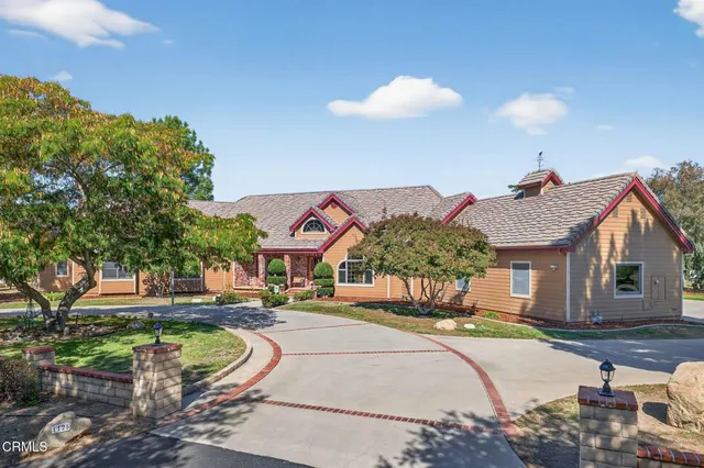 a view of a house with a yard and a street view