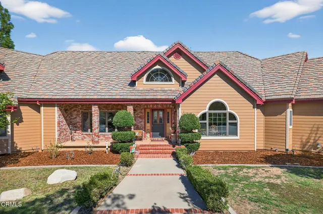 a front view of a house with garden