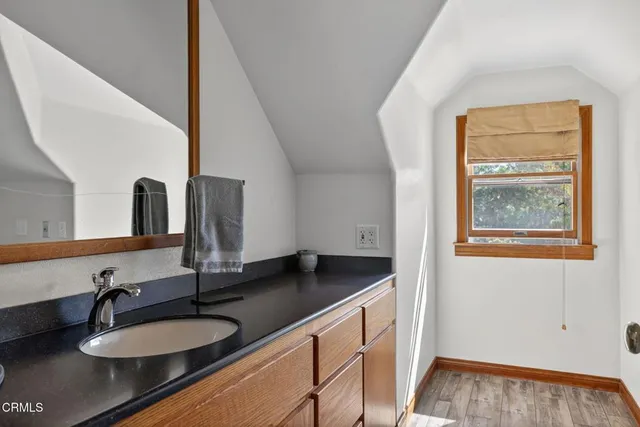 a view of a patio with a table and chairs under an umbrella