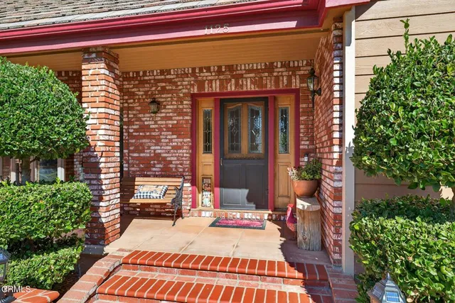 a view of living room filled with furniture and large windows