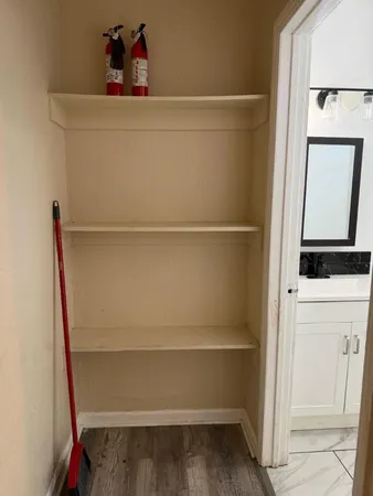 a view of storage and utility room with racks on the wall