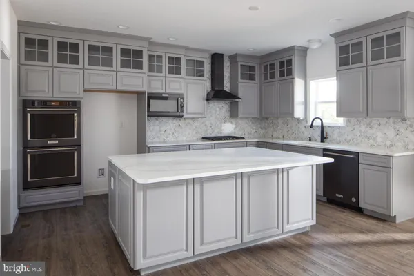 a kitchen with a stove a sink and a microwave