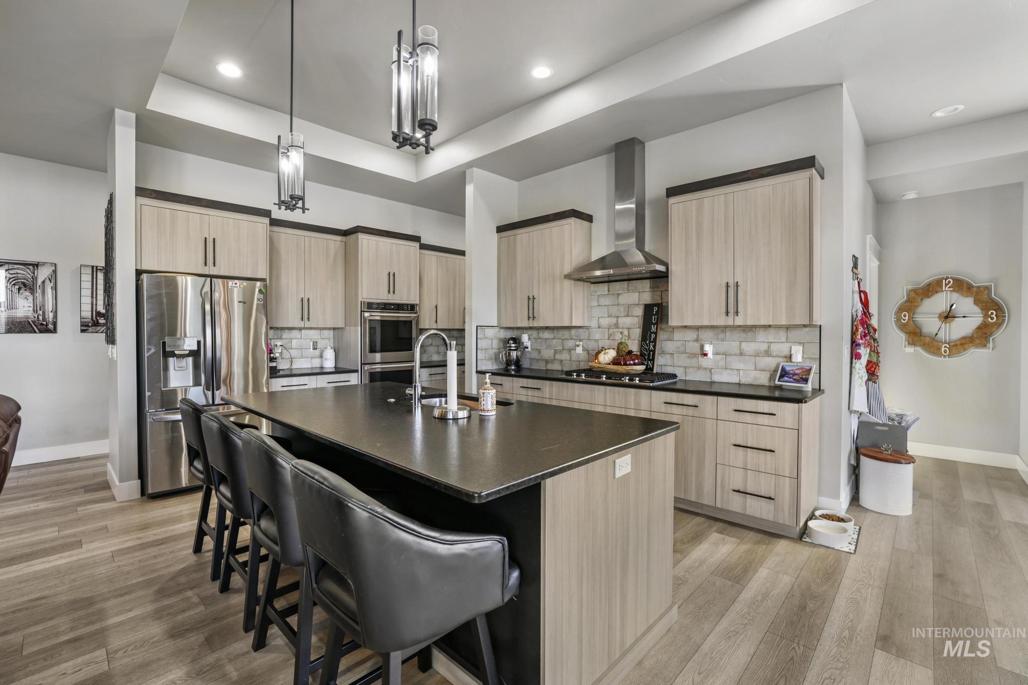 439 Meadowview Lane Twin Falls, ID 83301 - Photo 12 of 48 Kitchen with light brown cabinetry, an island with sink, appliances with stainless steel finishes, and recessed lighting