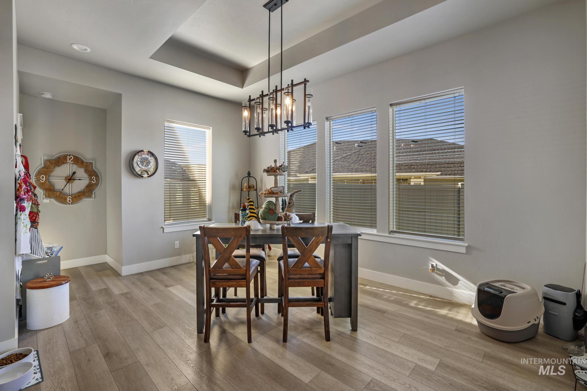 439 Meadowview Lane Twin Falls, ID 83301 - Photo 17 of 48 Dining room featuring a raised ceiling and light wood-type flooring