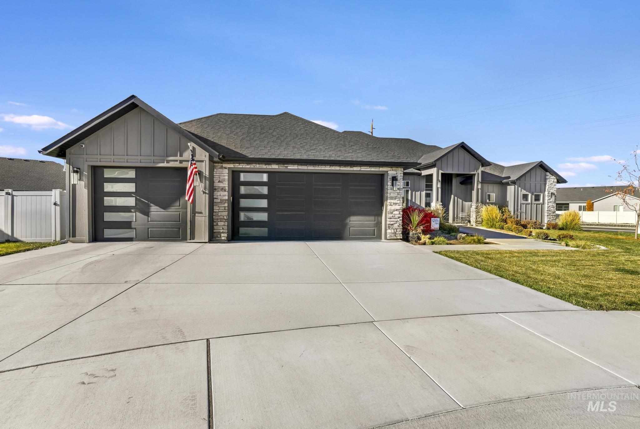 439 Meadowview Lane Twin Falls, ID 83301 - Photo 2 of 48 View of front of home featuring board and batten siding, stone siding, an attached garage, concrete driveway, and roof with shingles