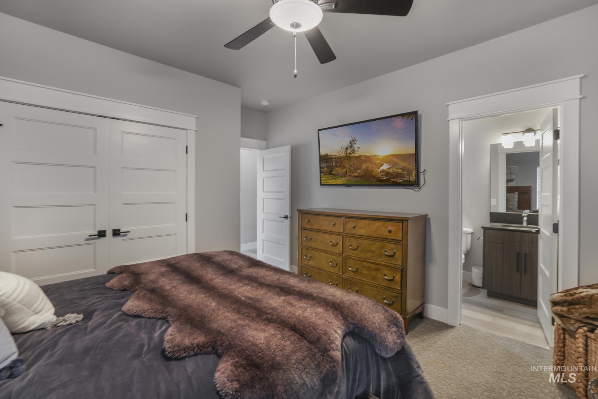 439 Meadowview Lane Twin Falls, ID 83301 - Photo 21 of 48 Carpeted bedroom with a closet, ceiling fan, and ensuite bath
