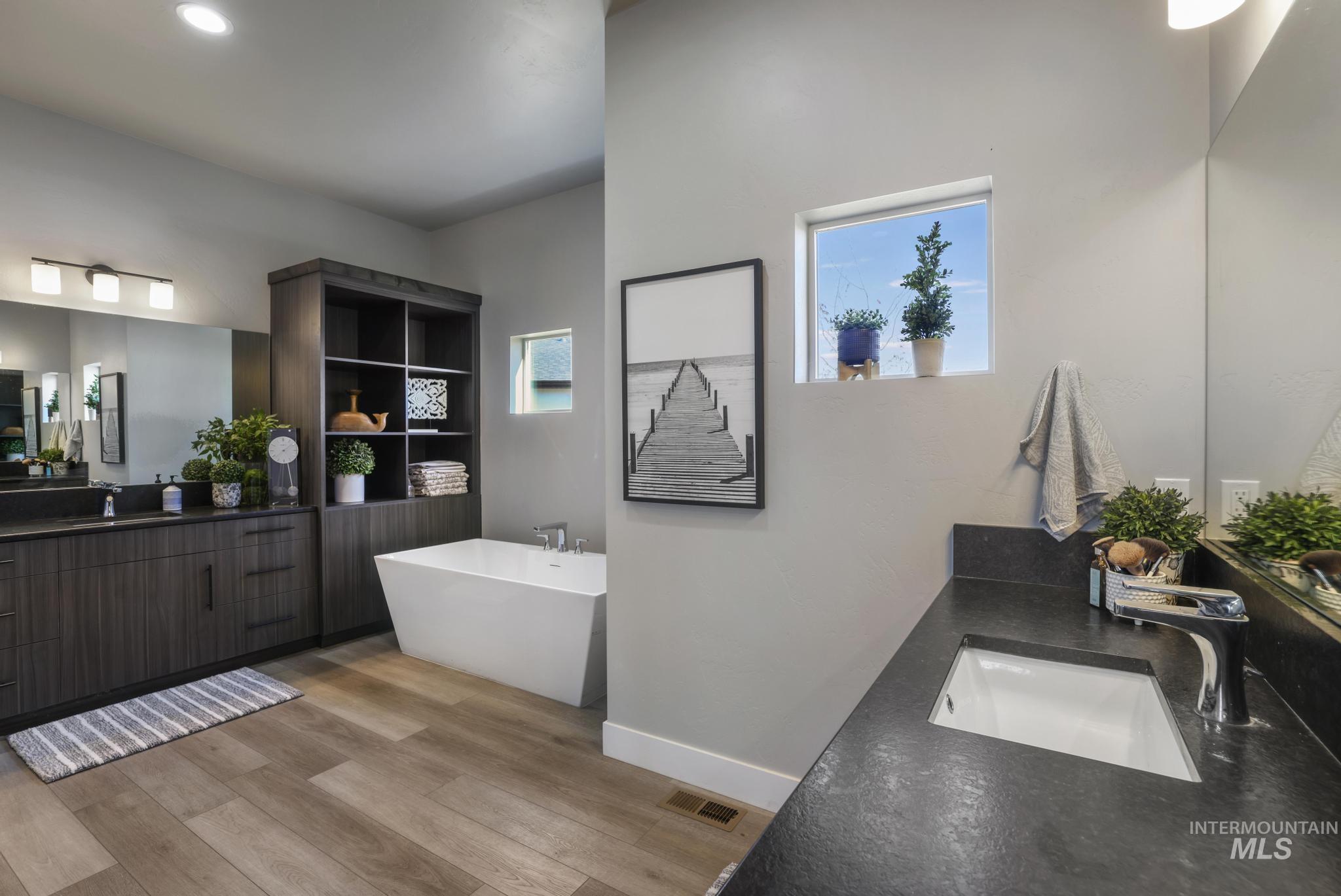 439 Meadowview Lane Twin Falls, ID 83301 - Photo 31 of 48 Bathroom with vanity, a soaking tub, light wood-type flooring, and recessed lighting