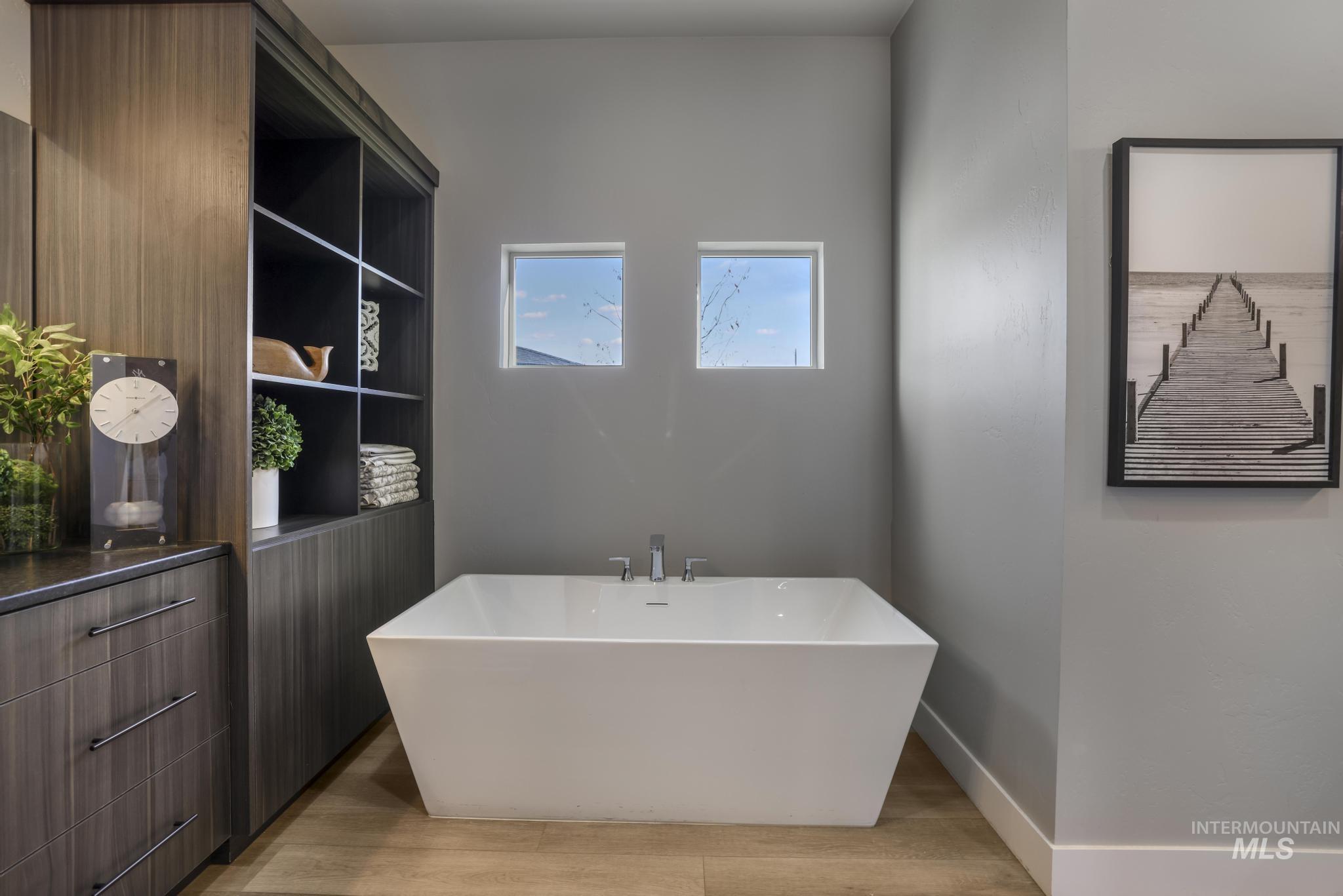 439 Meadowview Lane Twin Falls, ID 83301 - Photo 32 of 48 Bathroom featuring a soaking tub and light wood-style floors
