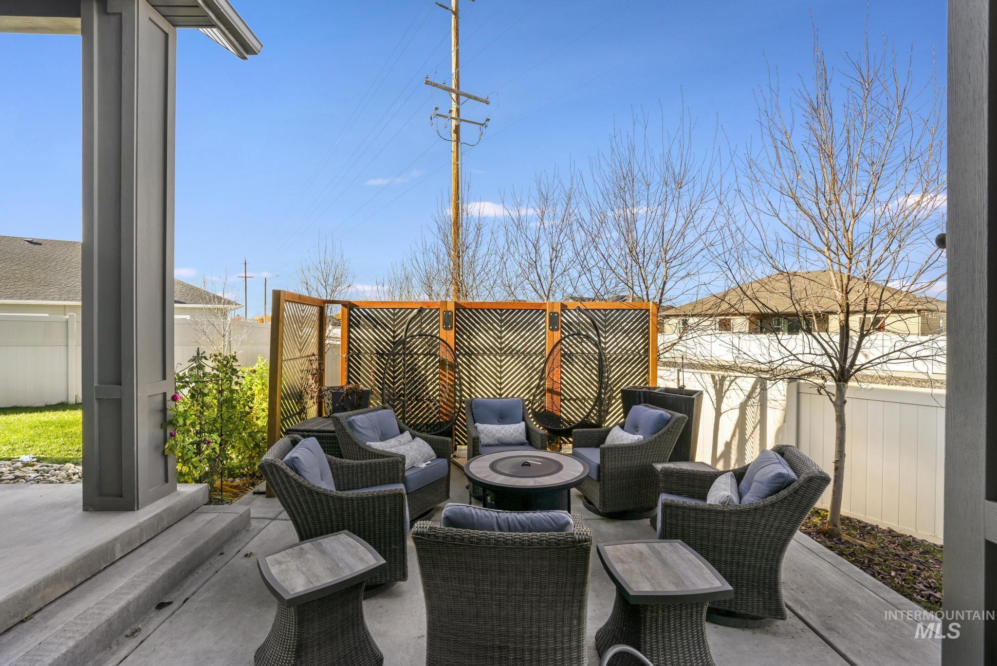 439 Meadowview Lane Twin Falls, ID 83301 - Photo 35 of 48 Fenced backyard with a patio area and an outdoor living space with a fire pit