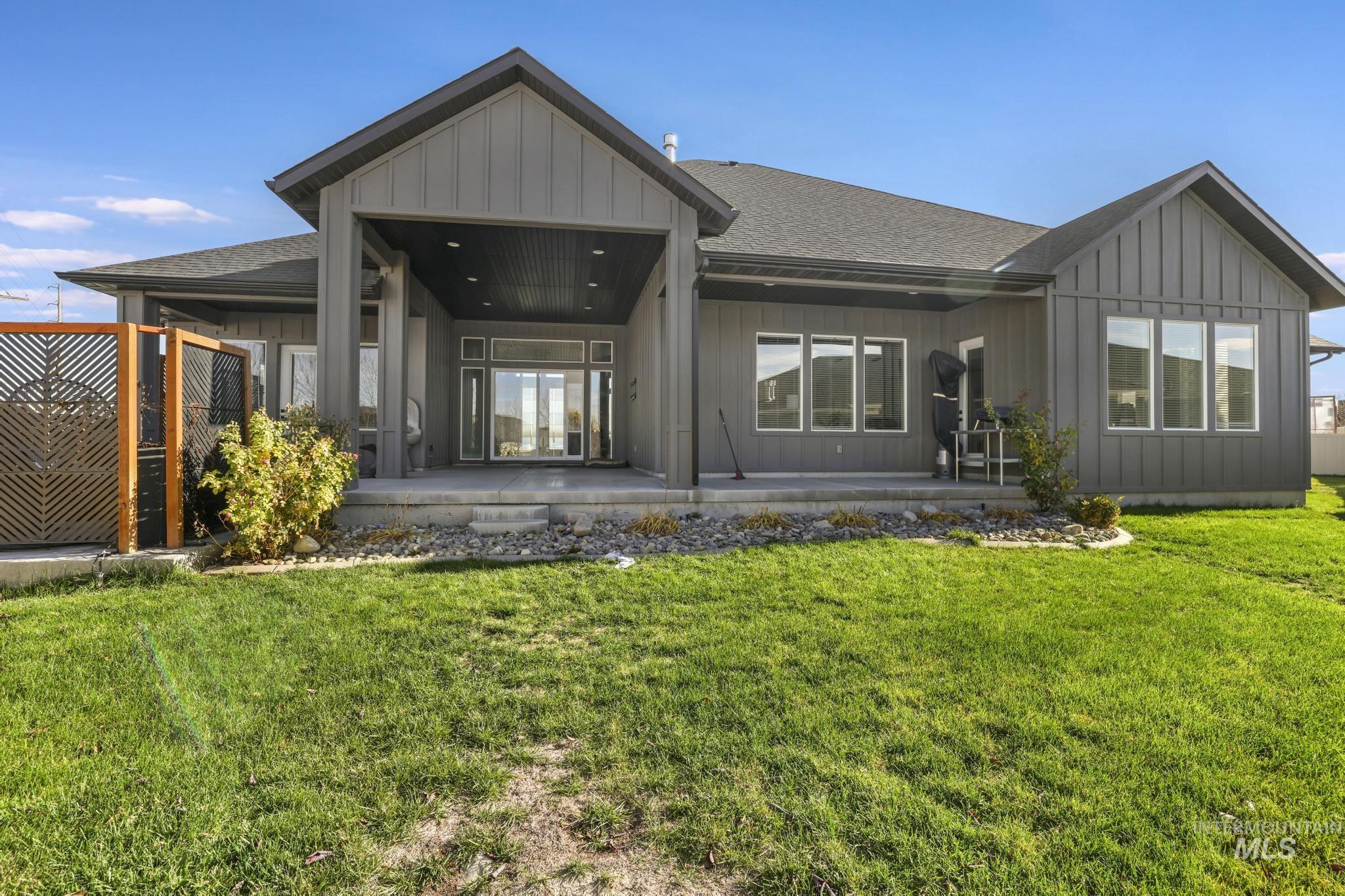 439 Meadowview Lane Twin Falls, ID 83301 - Photo 37 of 48 Back of property with roof with shingles, board and batten siding, a patio area, and french doors