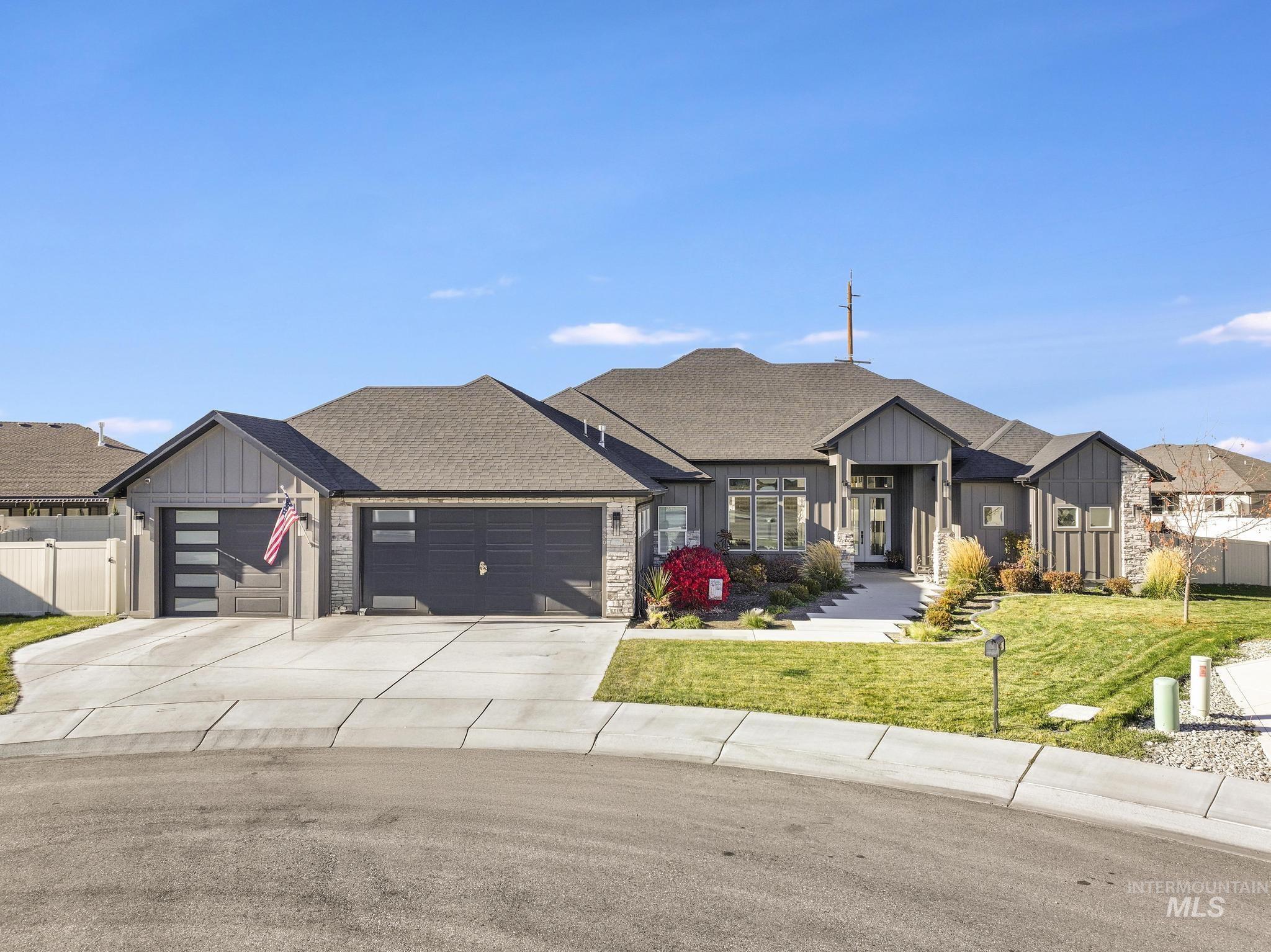 439 Meadowview Lane Twin Falls, ID 83301 - Photo 40 of 48 Modern inspired farmhouse featuring board and batten siding, concrete driveway, a shingled roof, a garage, and stone siding