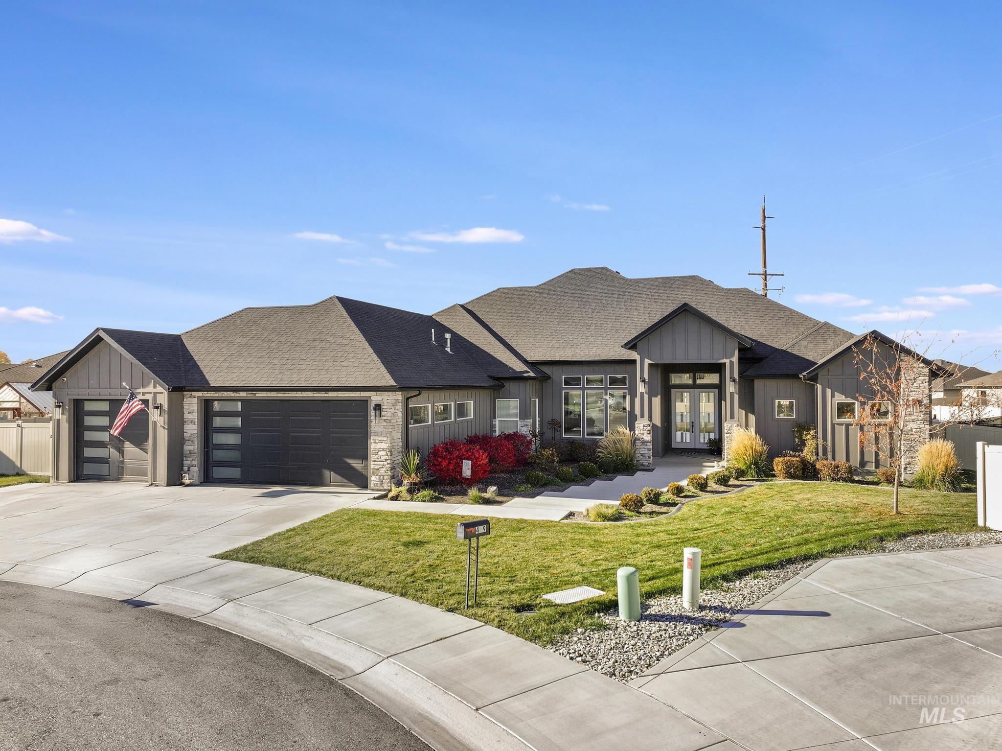 439 Meadowview Lane Twin Falls, ID 83301 - Photo 41 of 48 Modern inspired farmhouse featuring board and batten siding, stone siding, a shingled roof, a front yard, and driveway