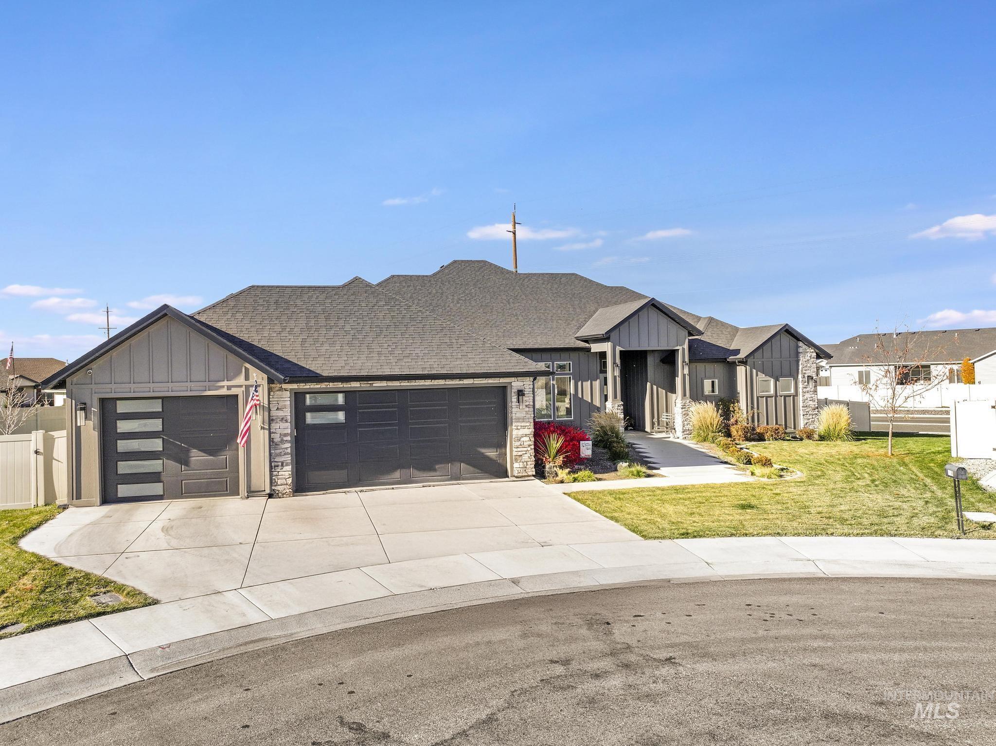 439 Meadowview Lane Twin Falls, ID 83301 - Photo 42 of 48 View of front of property featuring board and batten siding, a garage, driveway, and stone siding