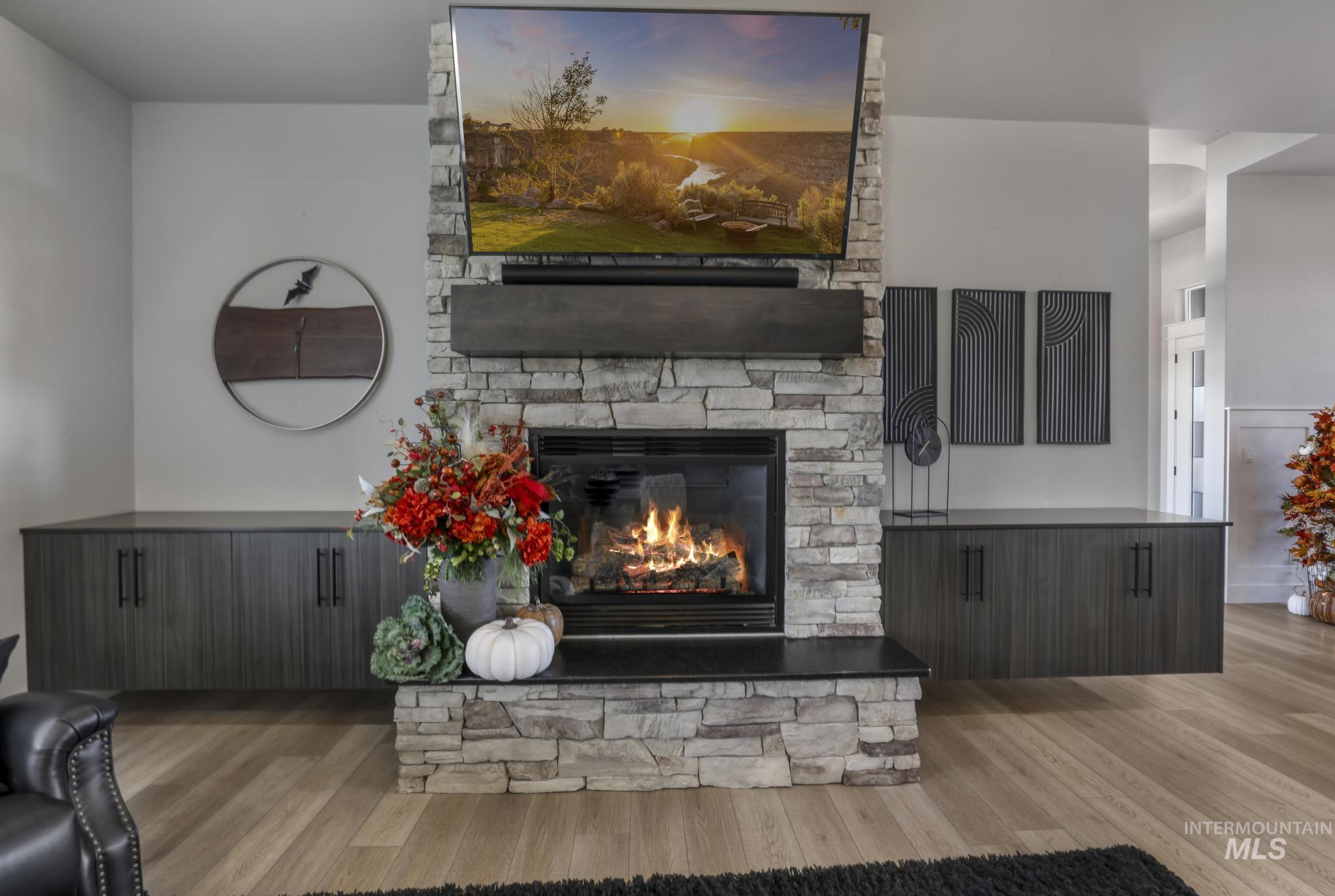 439 Meadowview Lane Twin Falls, ID 83301 - Photo 10 of 48 Living area with light wood-style floors and a fireplace