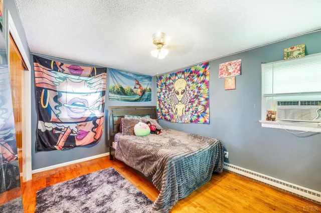 a bedroom with bed and a flat screen tv