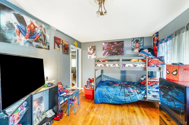 a living room with lots of baby toys on wooden floor and furniture