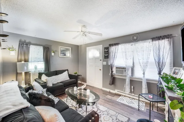 a living room with furniture a fireplace and a flat screen tv