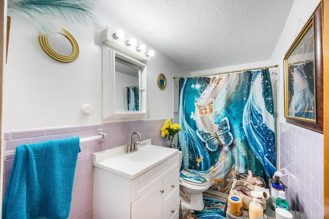 a bedroom with a bed a flat screen tv and a couch