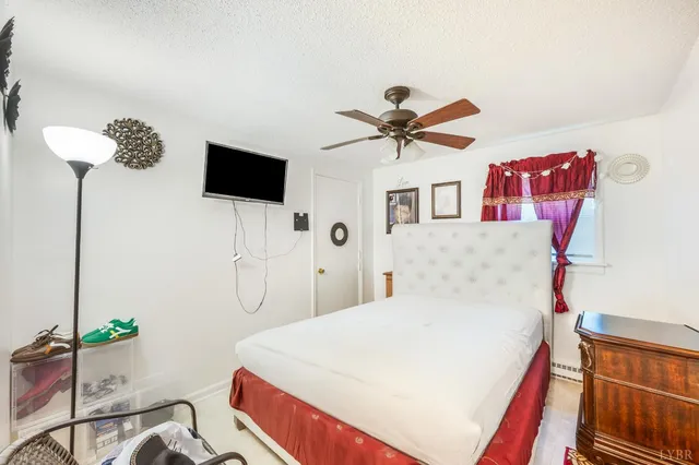 a bedroom with a bed and dresser with mirror