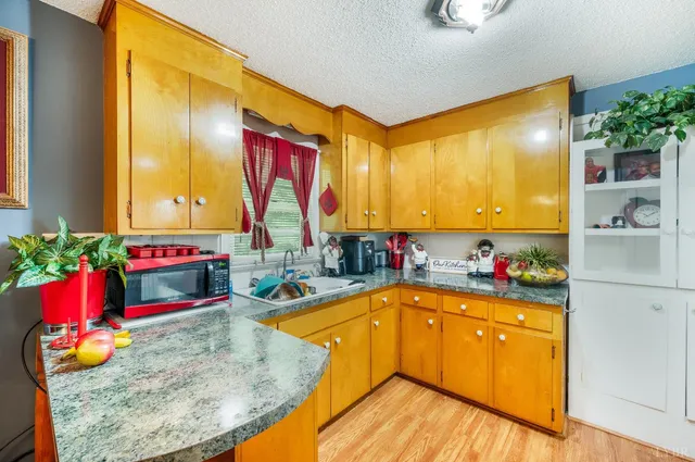 a kitchen with sink refrigerator and cabinets