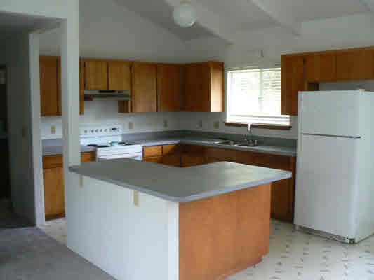 18-8023 North Kulani Road Mountain View, HI 96771 - Photo 5 of 9 a kitchen with a sink a stove a refrigerator and cabinets