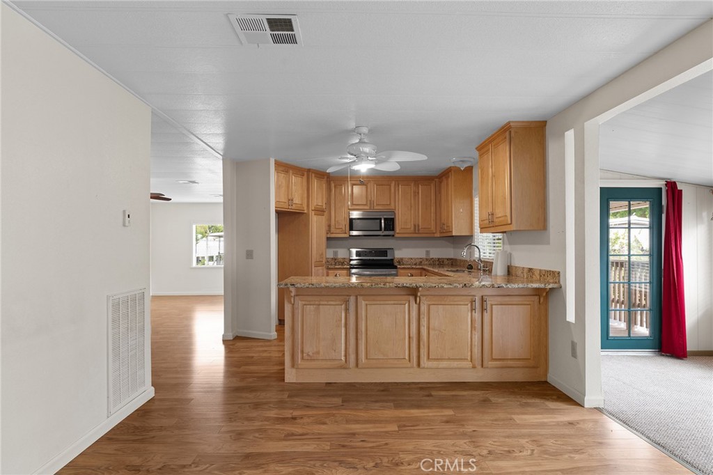 1901 Dayton, Unit 128 Chico, CA 95928 - Photo 7 of 44 a kitchen with stainless steel appliances granite countertop a refrigerator a stove and a sink