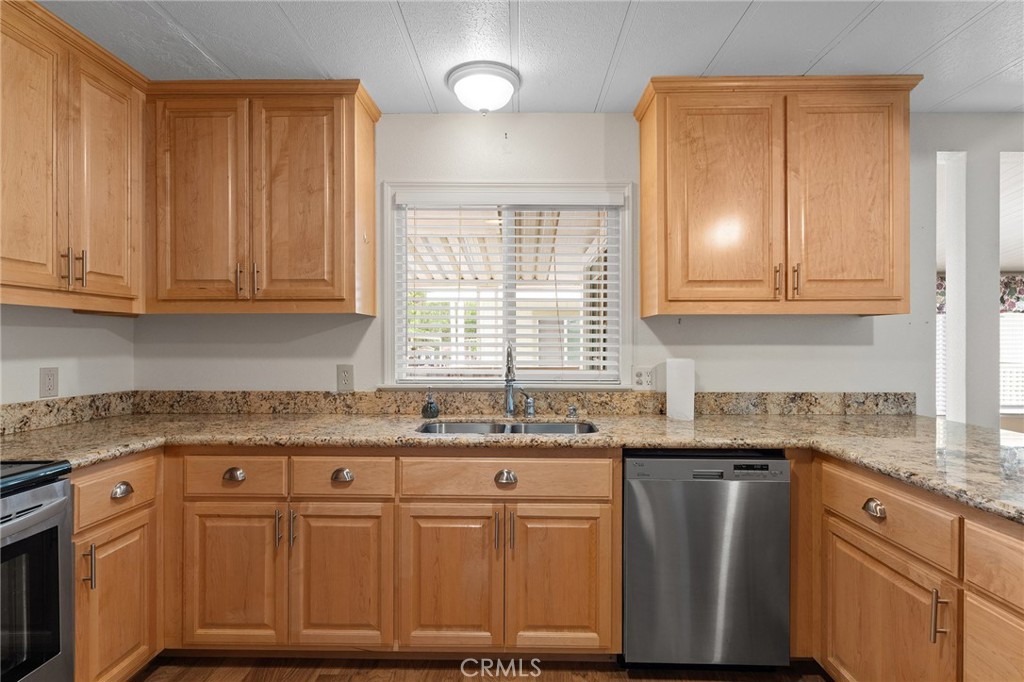 1901 Dayton, Unit 128 Chico, CA 95928 - Photo 9 of 44 a kitchen with granite countertop cabinets sink and window