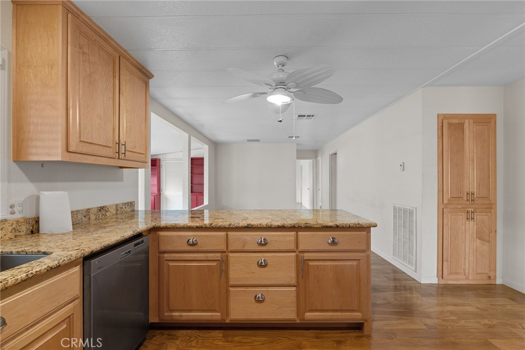 1901 Dayton, Unit 128 Chico, CA 95928 - Photo 10 of 44 a kitchen with stainless steel appliances granite countertop a sink cabinets and wooden floor