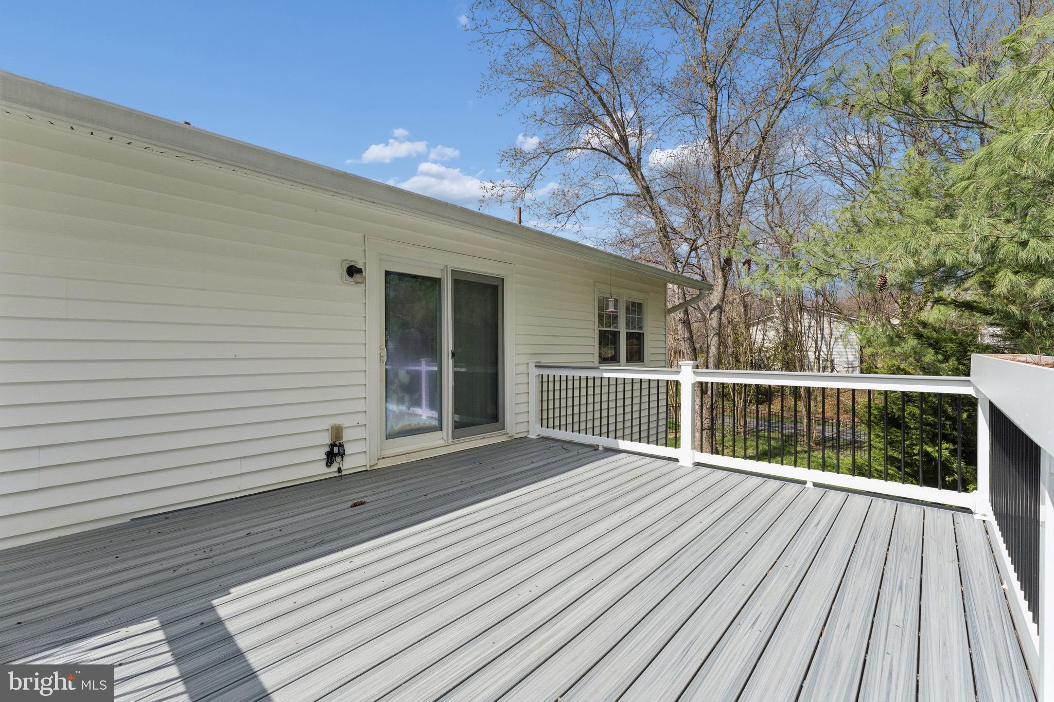 8910 Spur Road Springfield, VA 22153 - Photo 27 of 45 a view of a balcony with wooden floor and fence