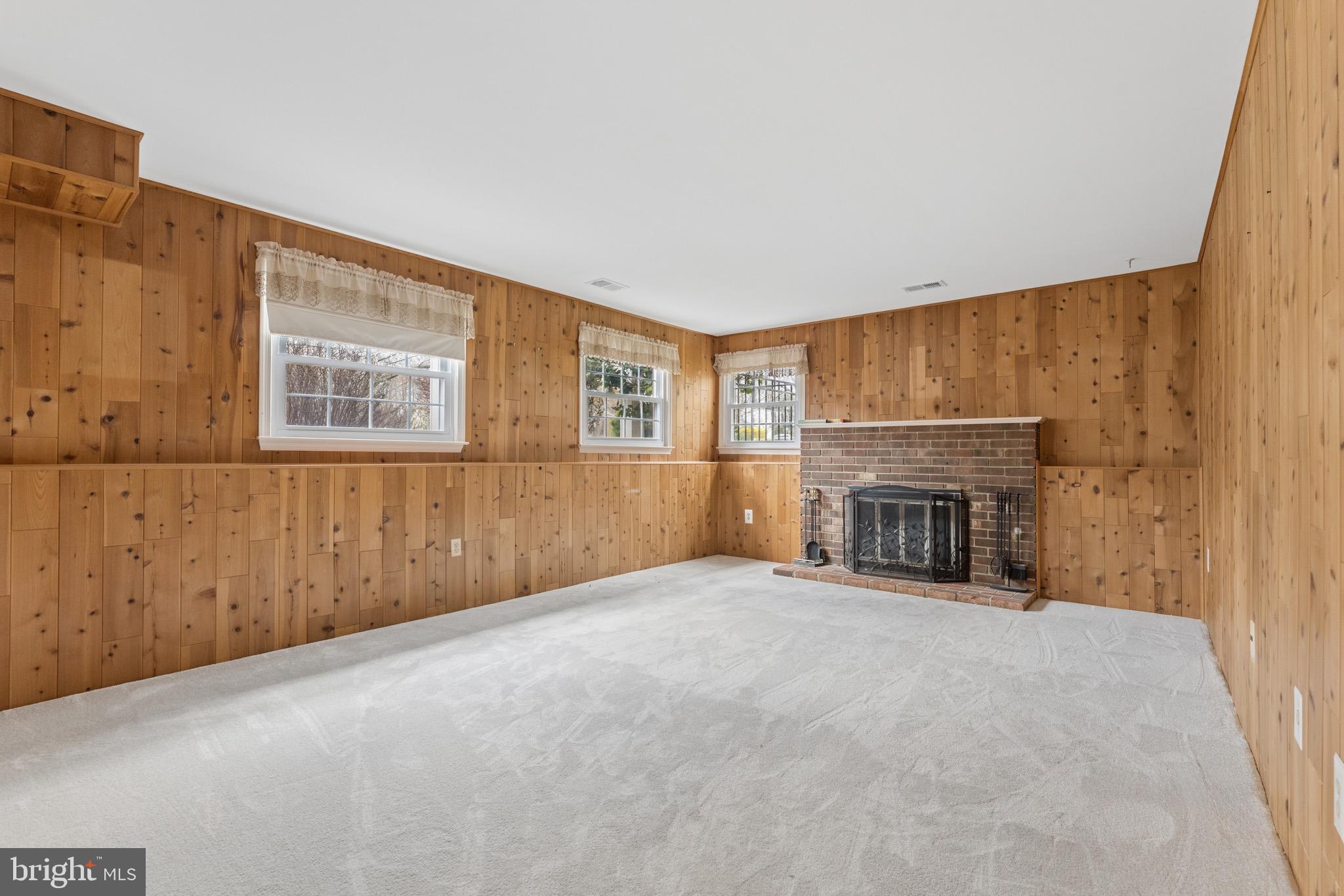 8910 Spur Road Springfield, VA 22153 - Photo 28 of 45 a view of an empty room with a fireplace and a window