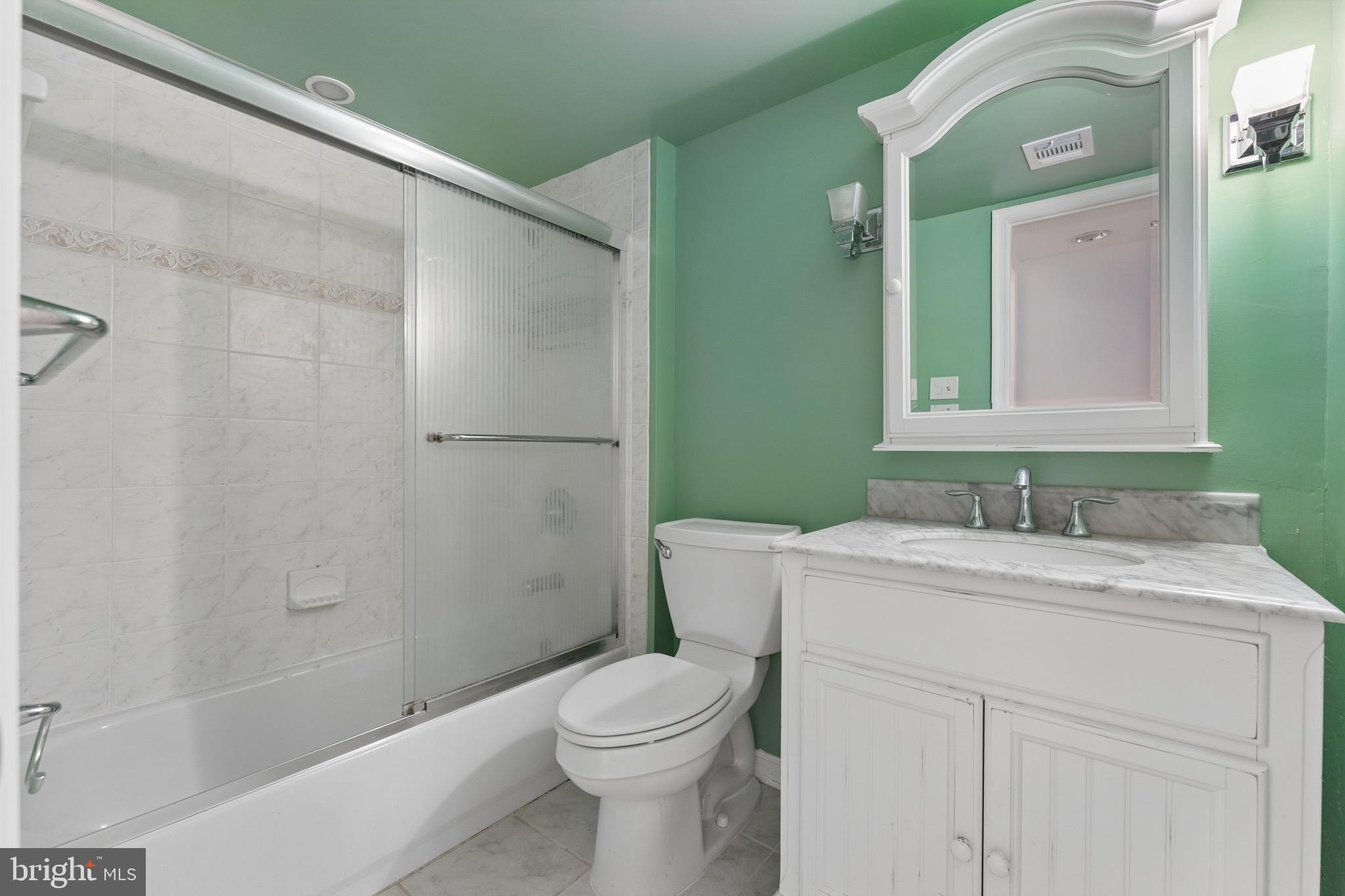 8910 Spur Road Springfield, VA 22153 - Photo 33 of 45 a bathroom with a sink a toilet and shower