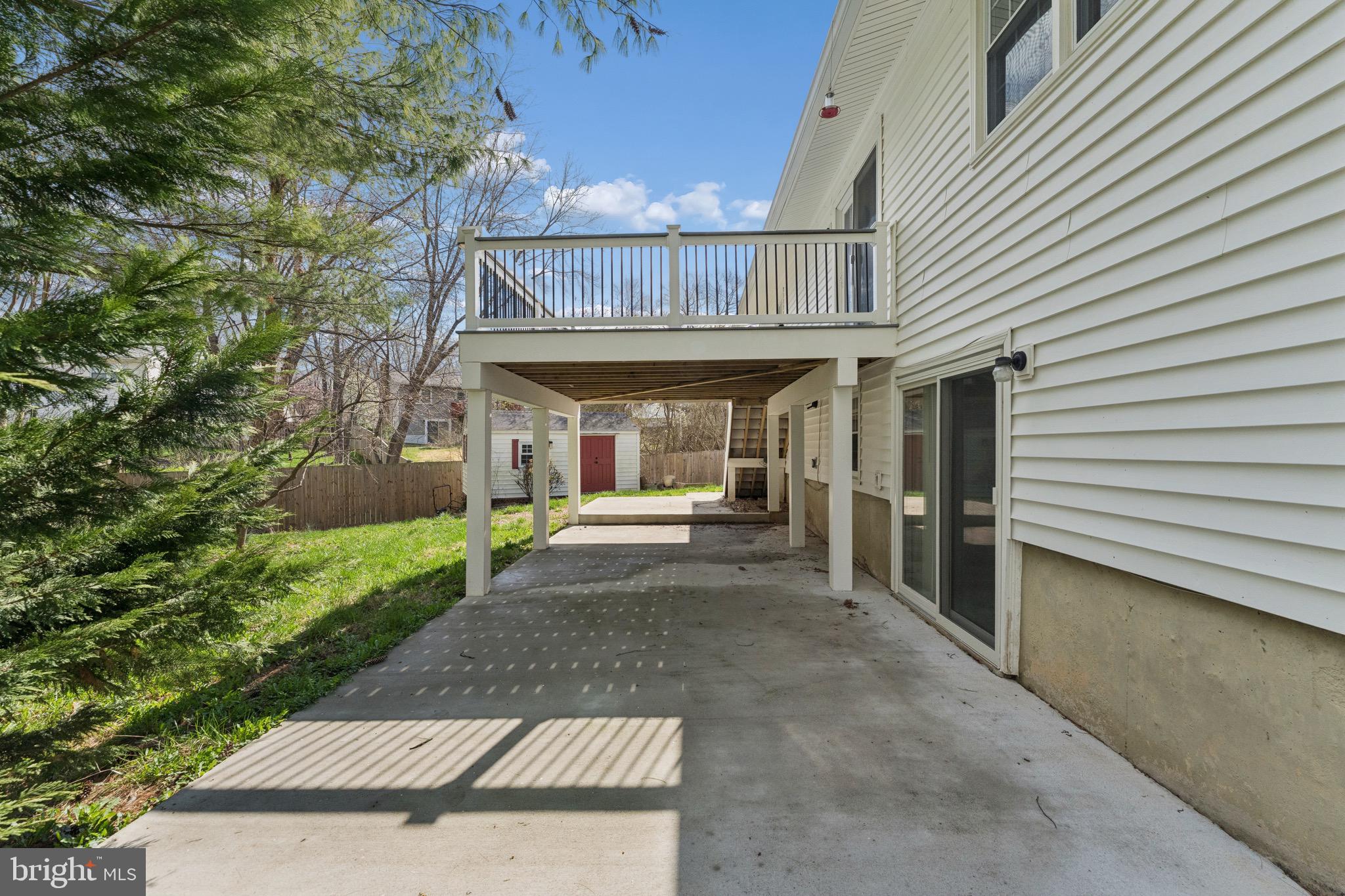 8910 Spur Road Springfield, VA 22153 - Photo 39 of 45 a view of a patio with table and chairs and a large tree