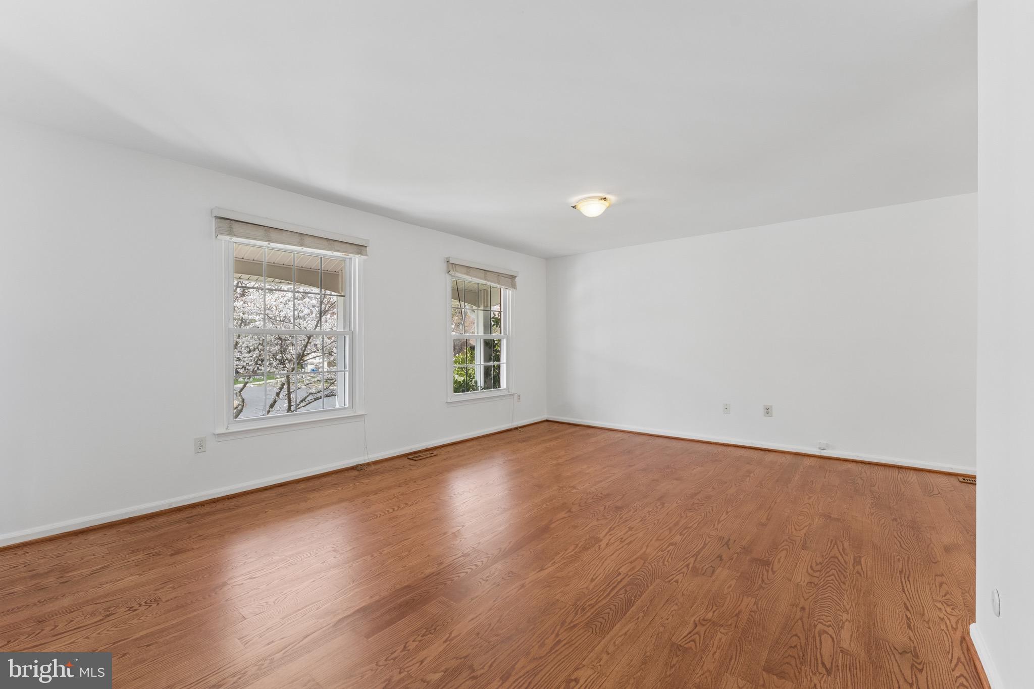8910 Spur Road Springfield, VA 22153 - Photo 4 of 45 an empty room with wooden floor and window