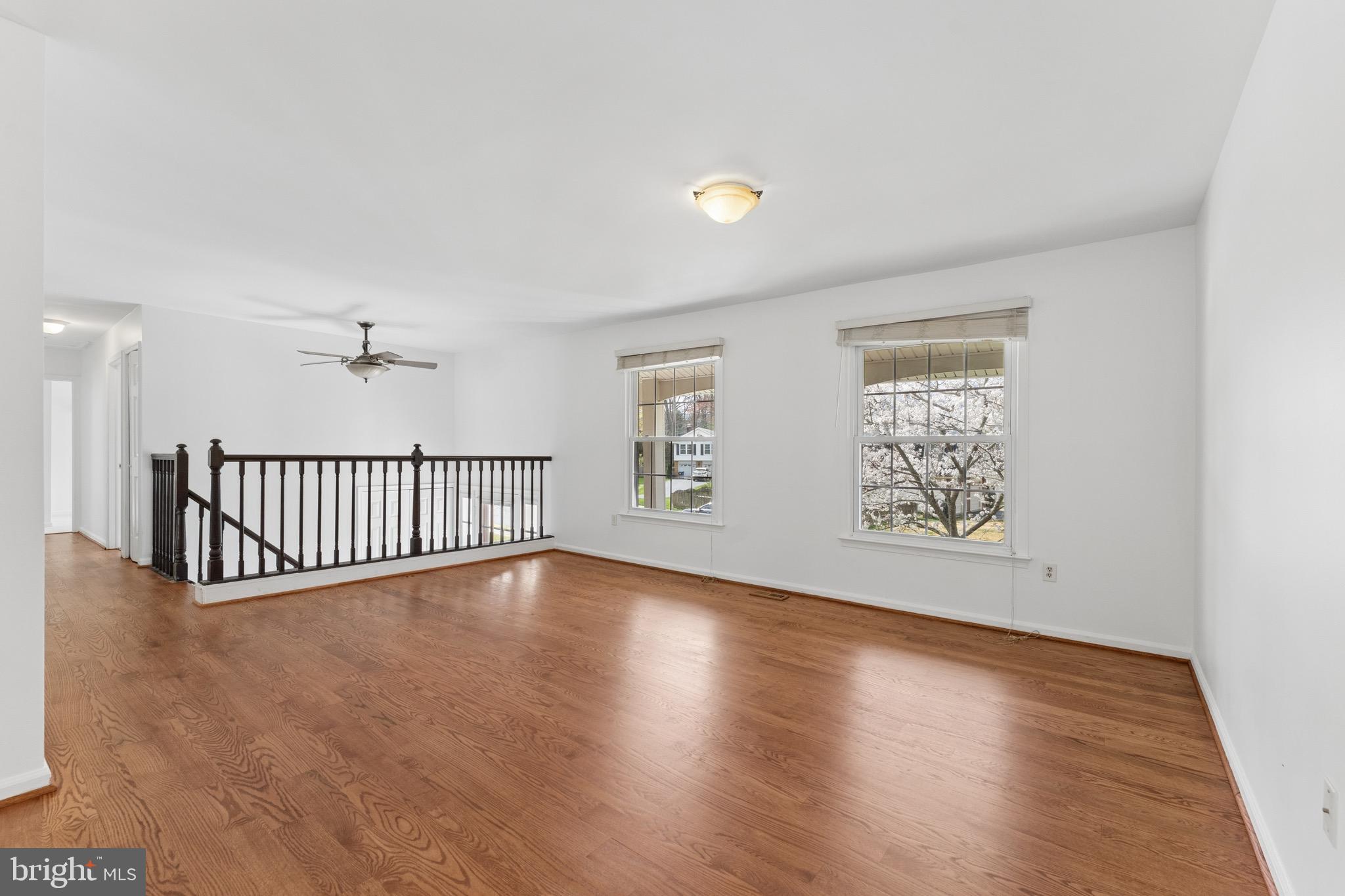 8910 Spur Road Springfield, VA 22153 - Photo 7 of 45 an empty room with wooden floor and windows