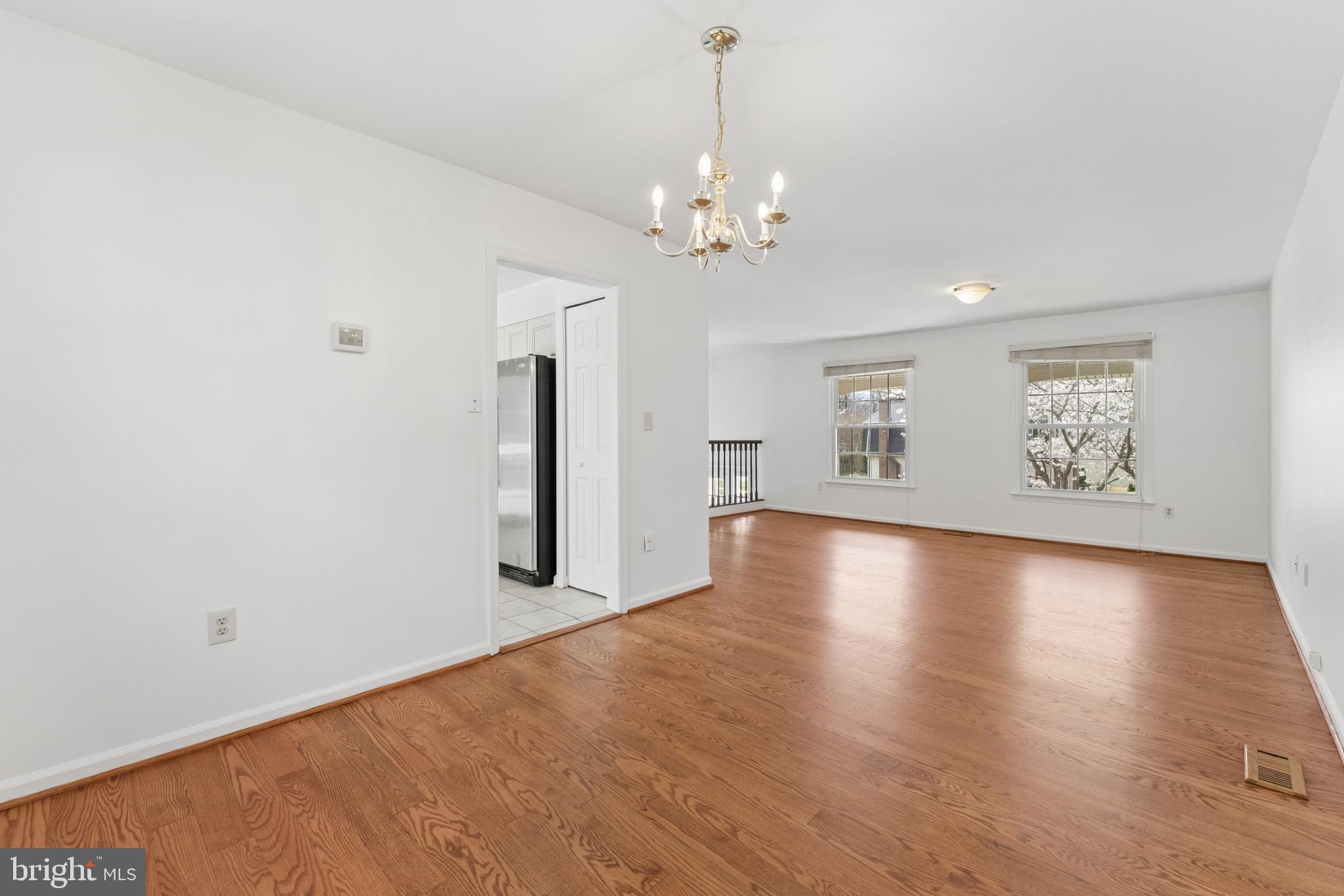 8910 Spur Road Springfield, VA 22153 - Photo 10 of 45 a view of an empty room with window and wooden floor