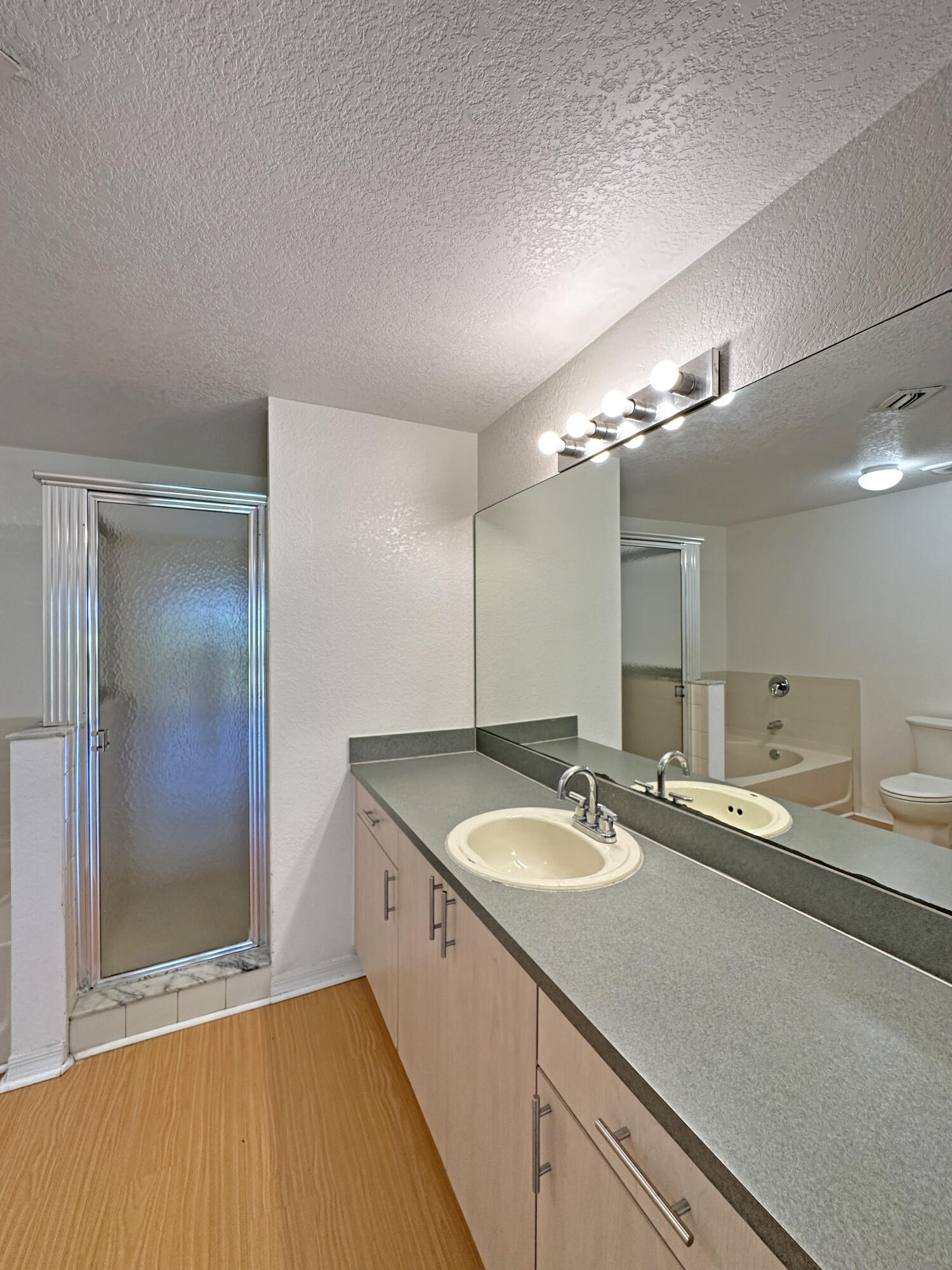 166 Southwest Peacock Boulevard, Unit 104 Port St. Lucie, FL 34986 - Photo 16 of 45 a bathroom with a sink and a mirror