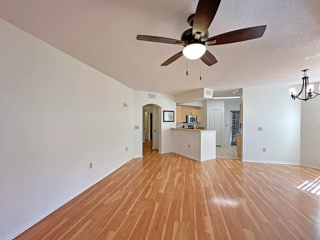 a view of empty room with wooden floor