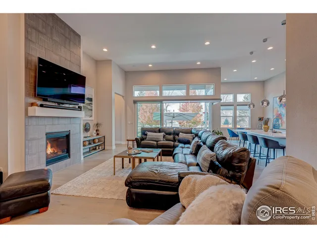 a living room with fireplace furniture and a flat screen tv