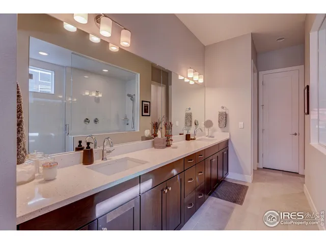 a bedroom with bed and two windows